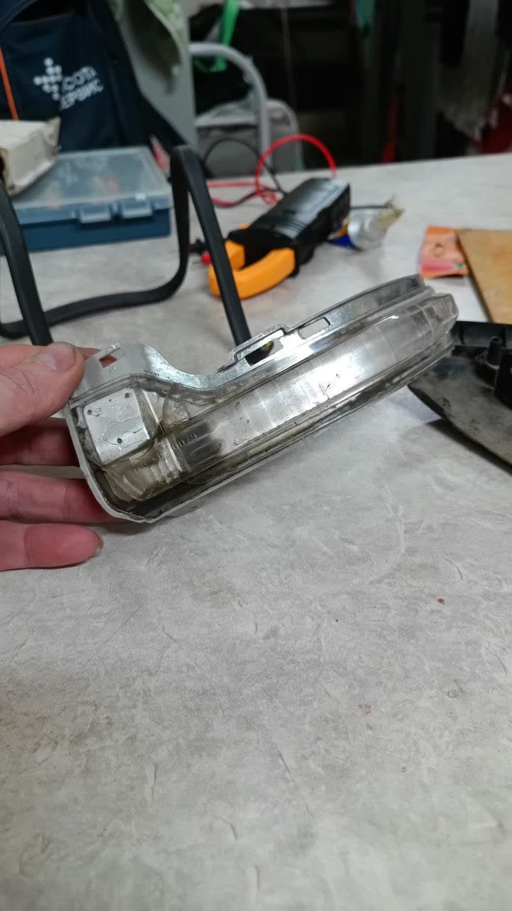 The sealed turn-signal repeater unit removed from the mirror housing