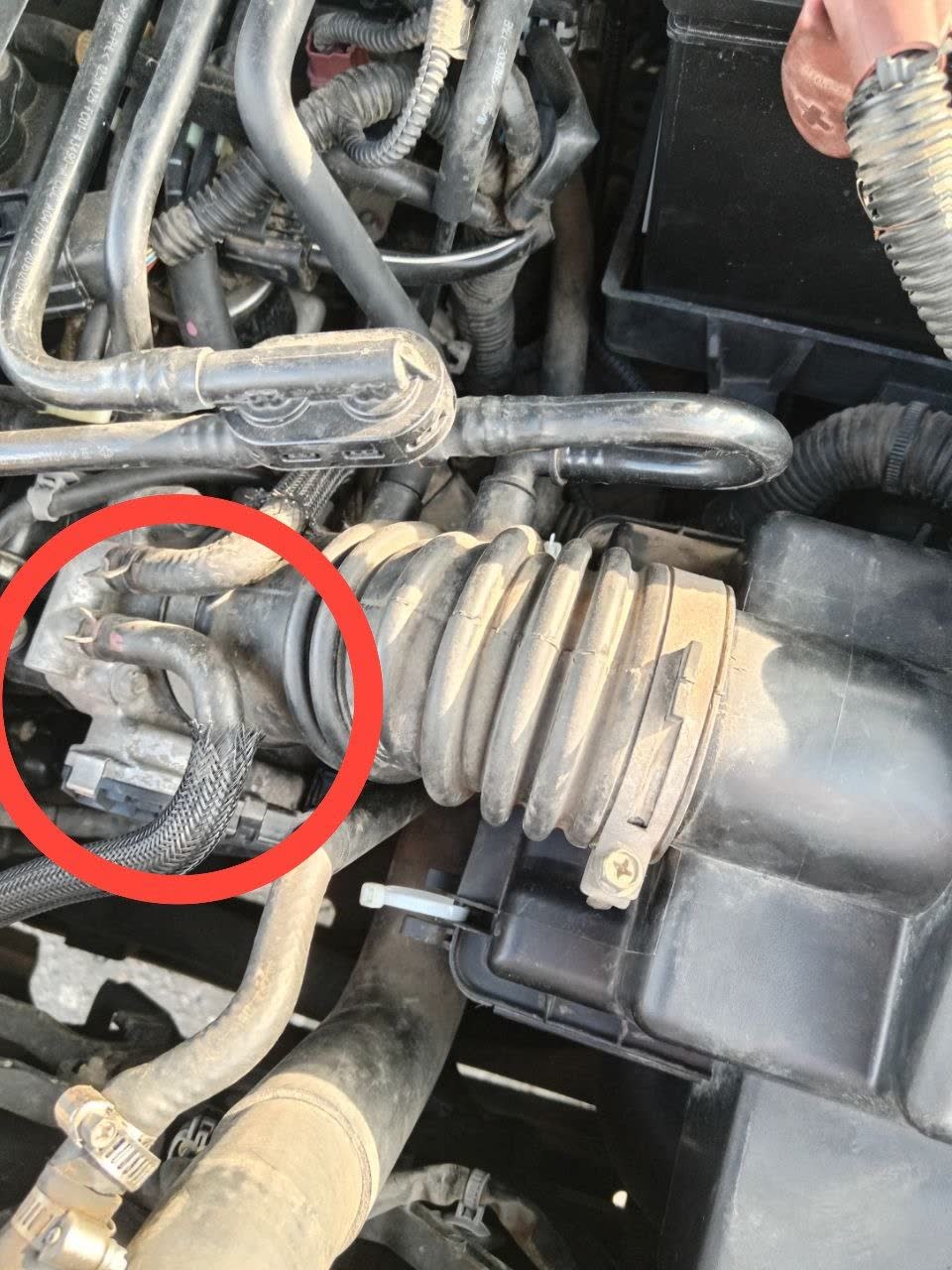 Engine bay photo with red circle highlighting MAP sensor location near the intake manifold (exhaust side); throttle body and MAP sensor location shown.