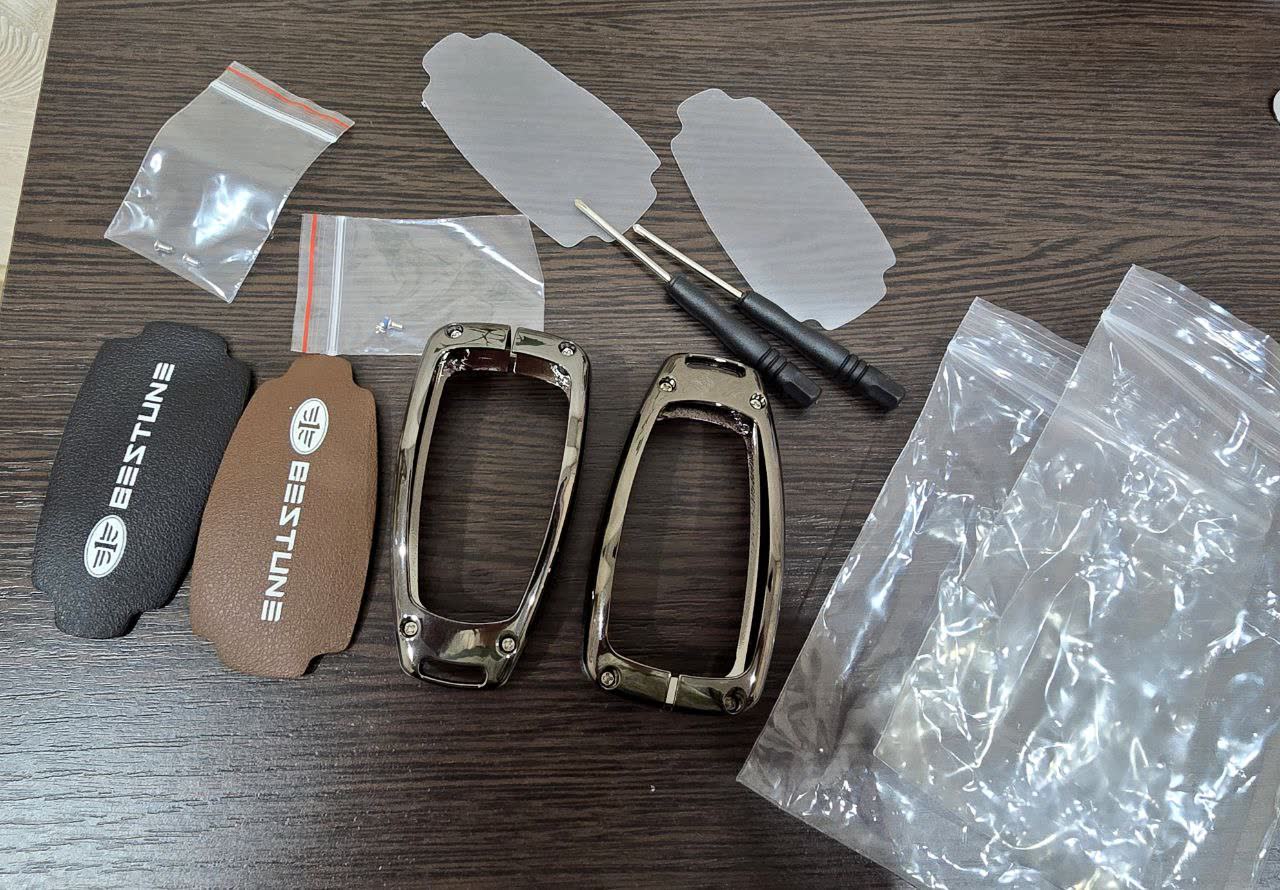 Leather key case received, showing metal case construction with bolt fasteners