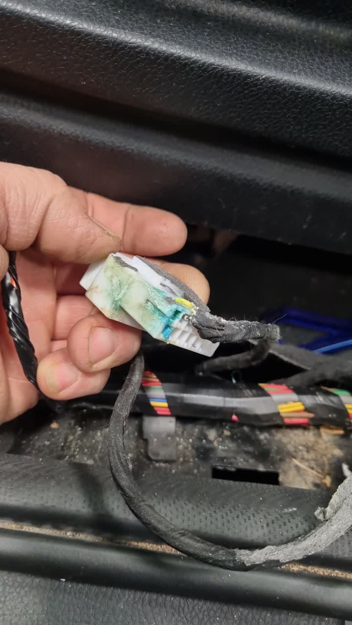 Connector showing heavy corrosion on contacts from water damage under the driver seat