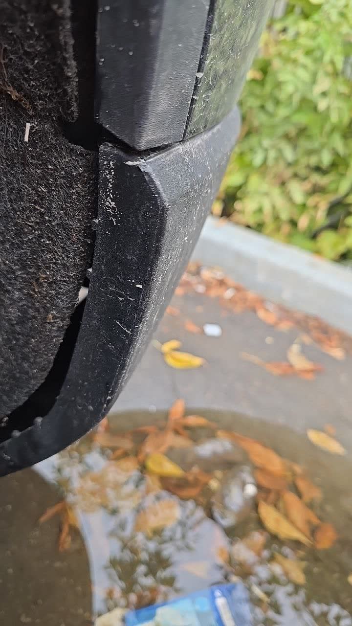 Factory mud guard — smooth plastic with no visible mounting holes