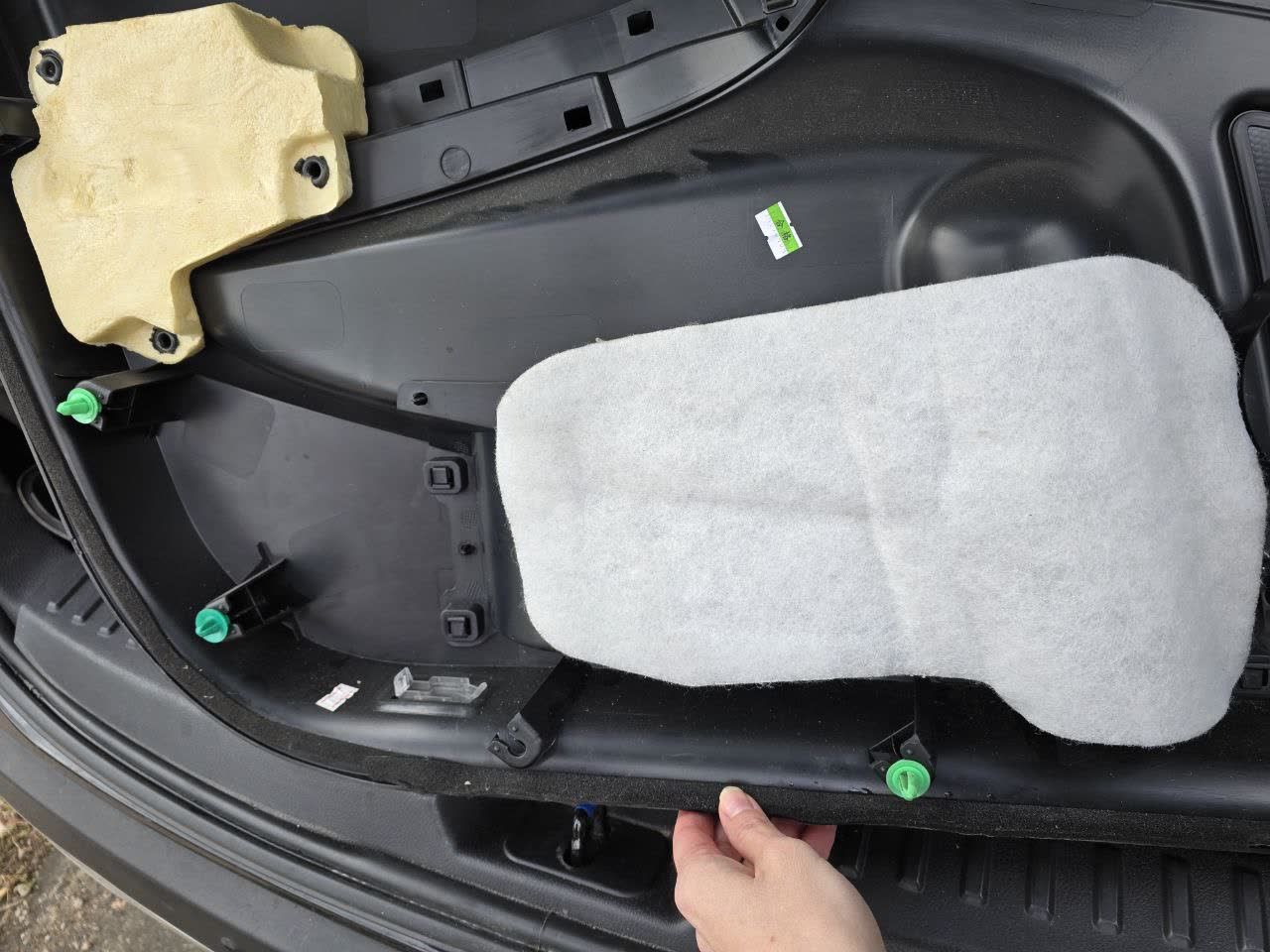 Door panel interior showing moisture and gray sponge padding