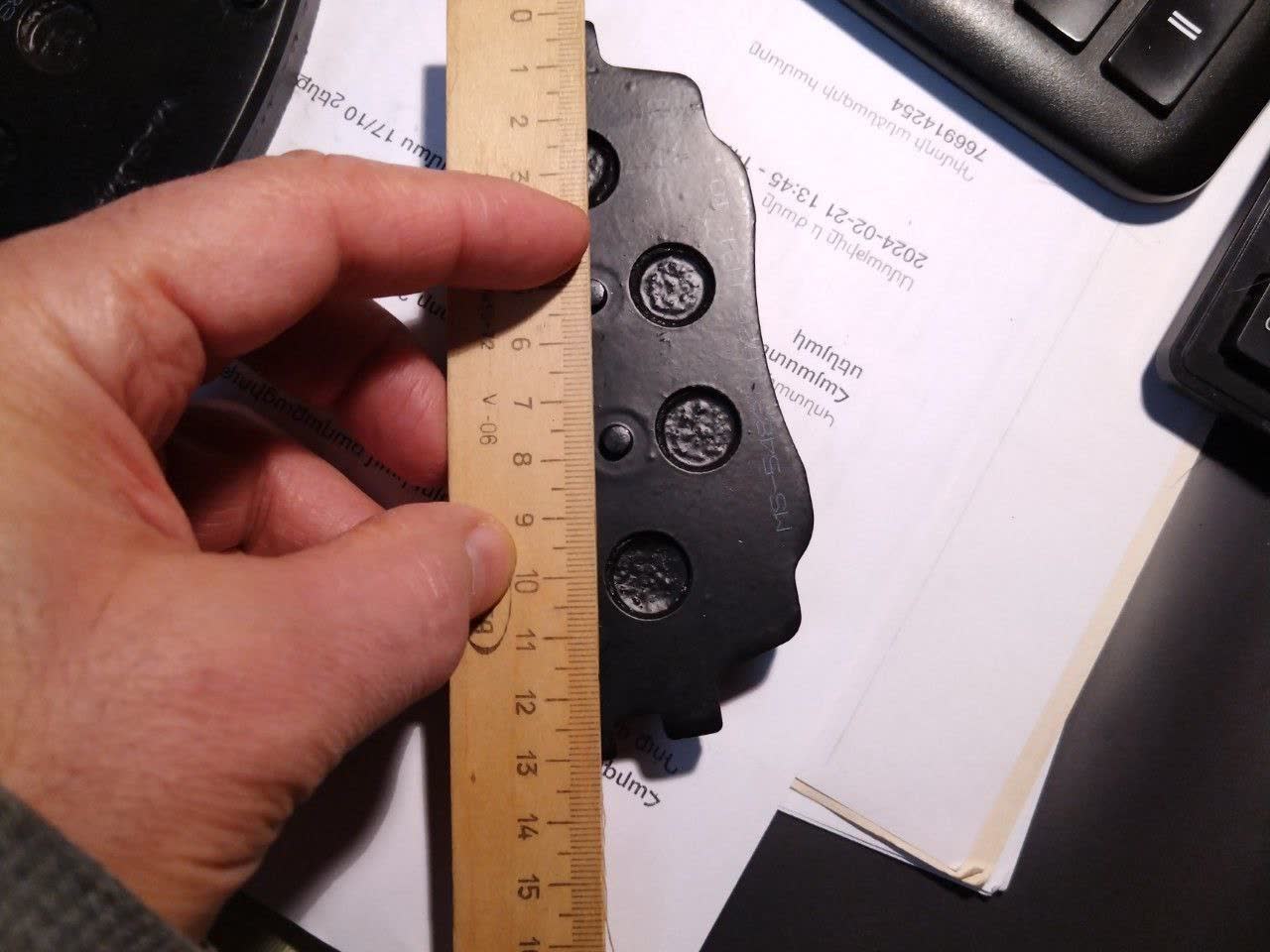 Second measurement photo confirming the Masuma pad undersizing versus the 133.1 mm X80 spec