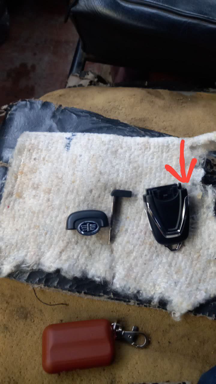Key fob opened, showing internal snap-clip construction and battery compartment