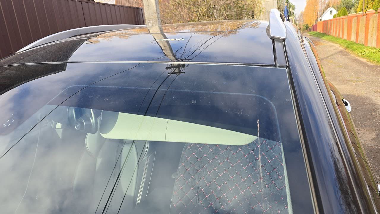 Windshield tint strip cut in curved pattern, showing legal width
