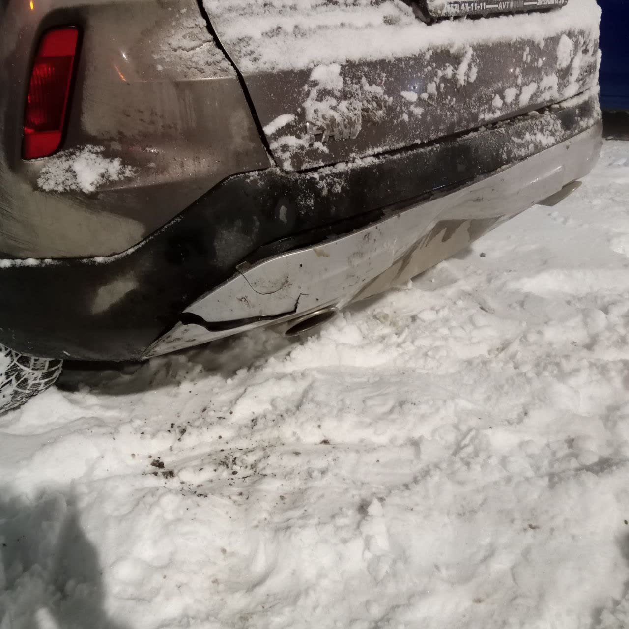 Rear bumper damage showing cracked lower trim section after rear-end impact