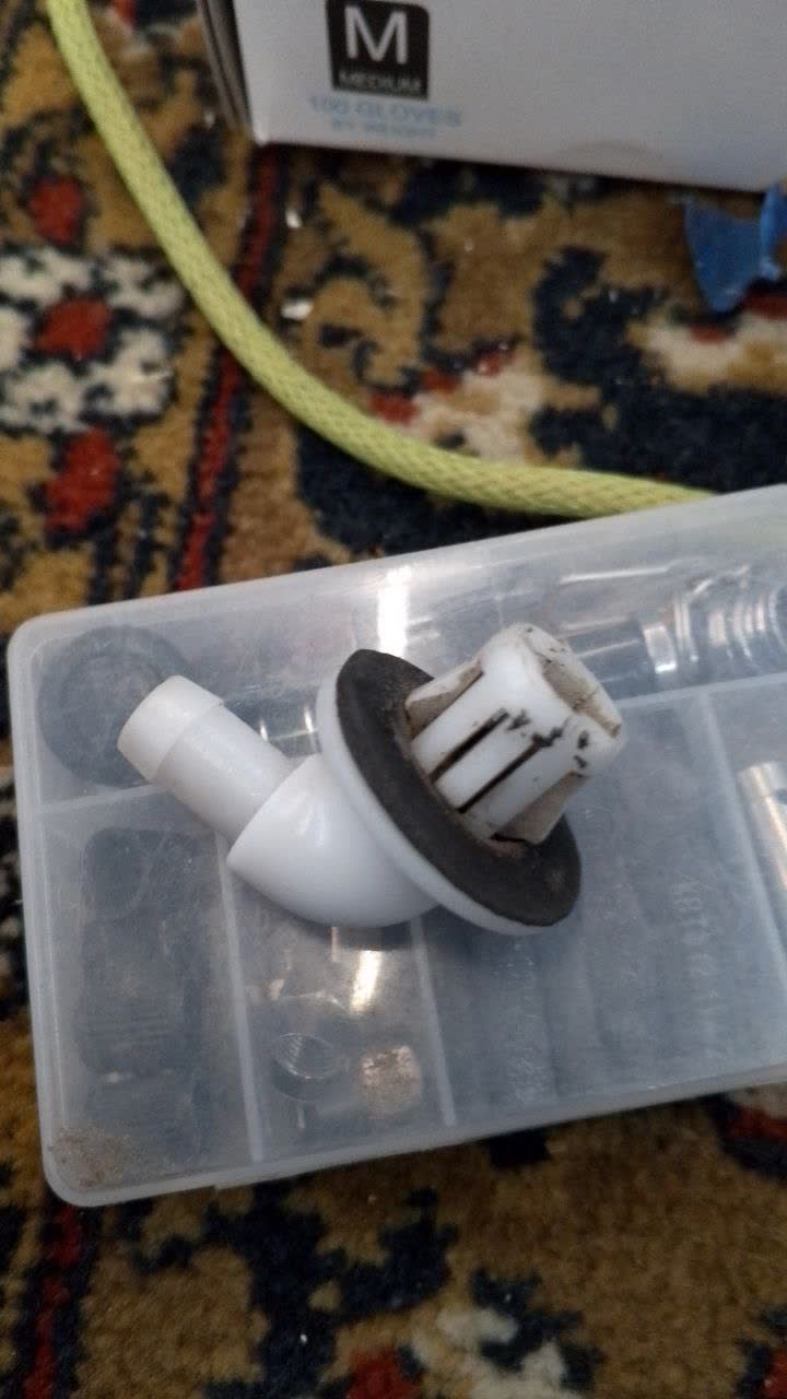 Roof drain connection points on windshield strut area with blue drain tubing visible