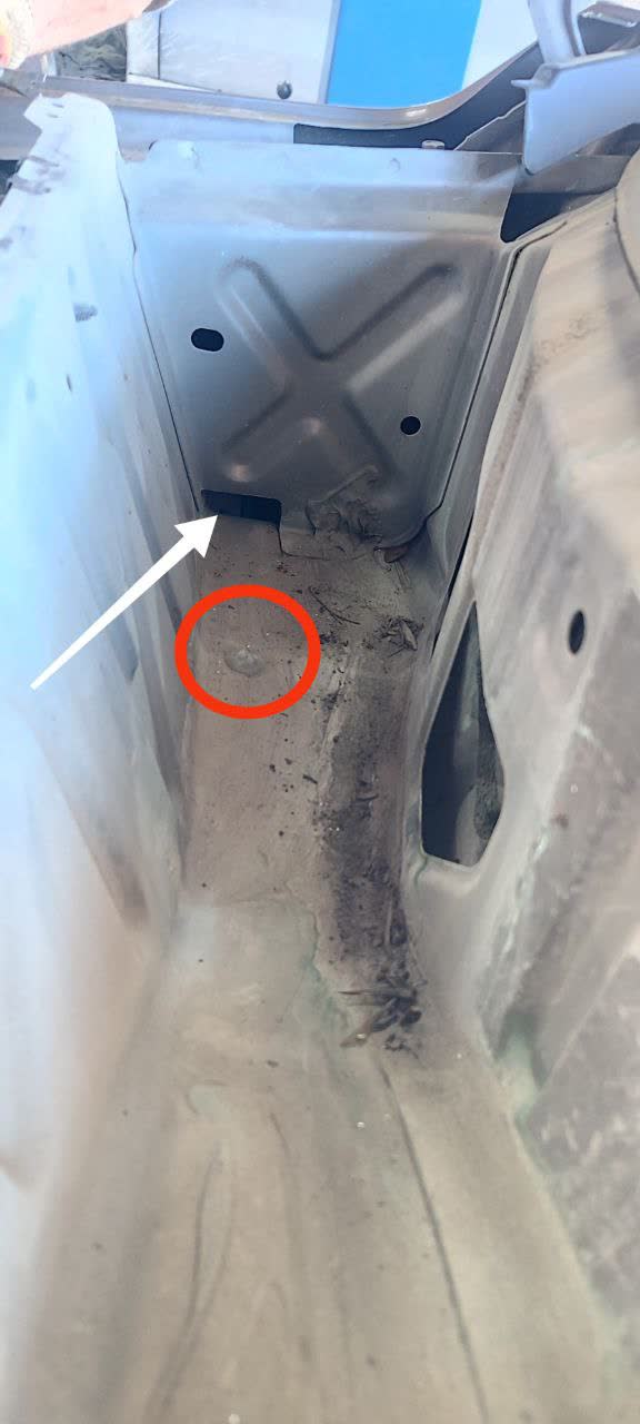 Rain pan investigation showing drain holes and internal partitions