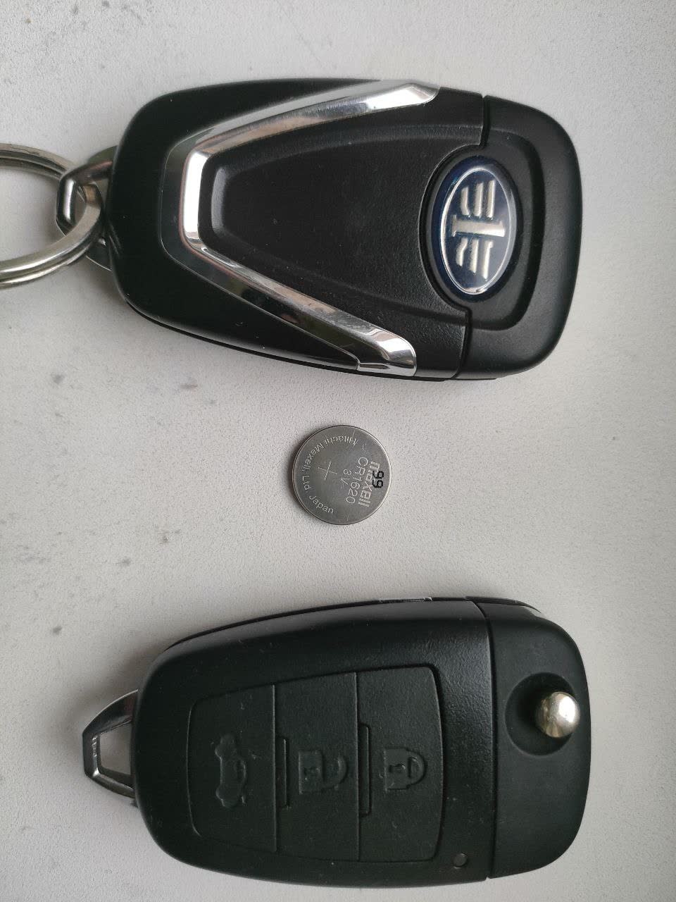 CR1620 battery removed from a base-trim mechanical key