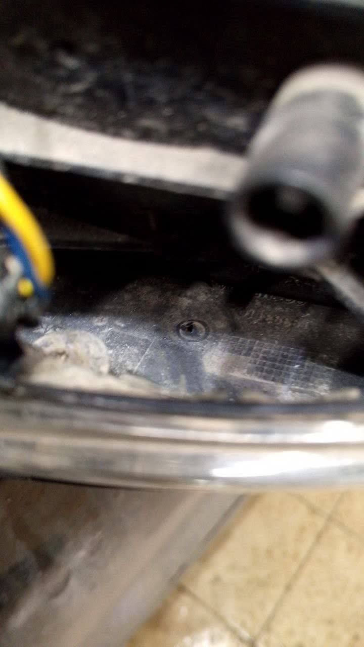 Photo of mirror housing interior, asked about drill marking location
