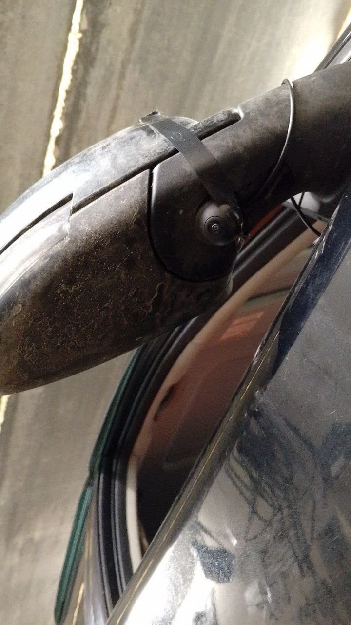Photo showing the molded circle marking on the mirror housing for camera position