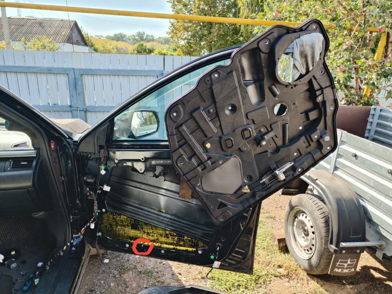 Door interior trim removed, exposing the window regulator and mounting points