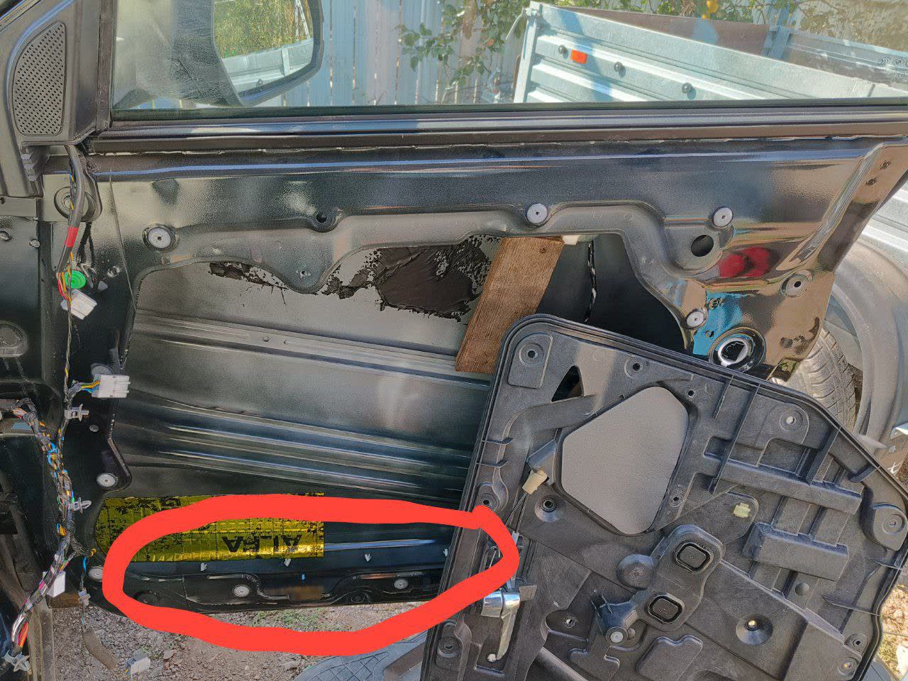 Second view of the removed door trim, showing further mounting detail