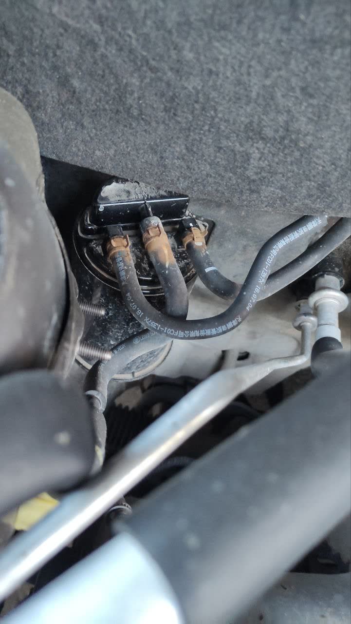 Close-up photo of the hose end/routing near the right headlight area
