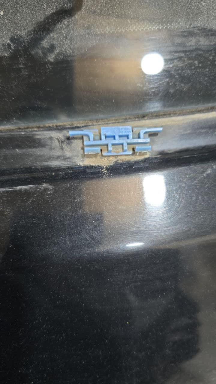 Photo of the trunk chrome trim/molding showing rust susceptibility around the clip attachment points