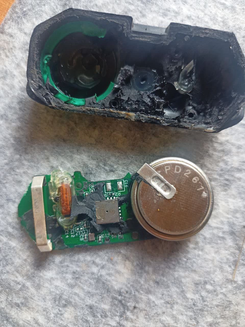 Disassembled TPMS sensor after solvent soak, board exposed for battery replacement