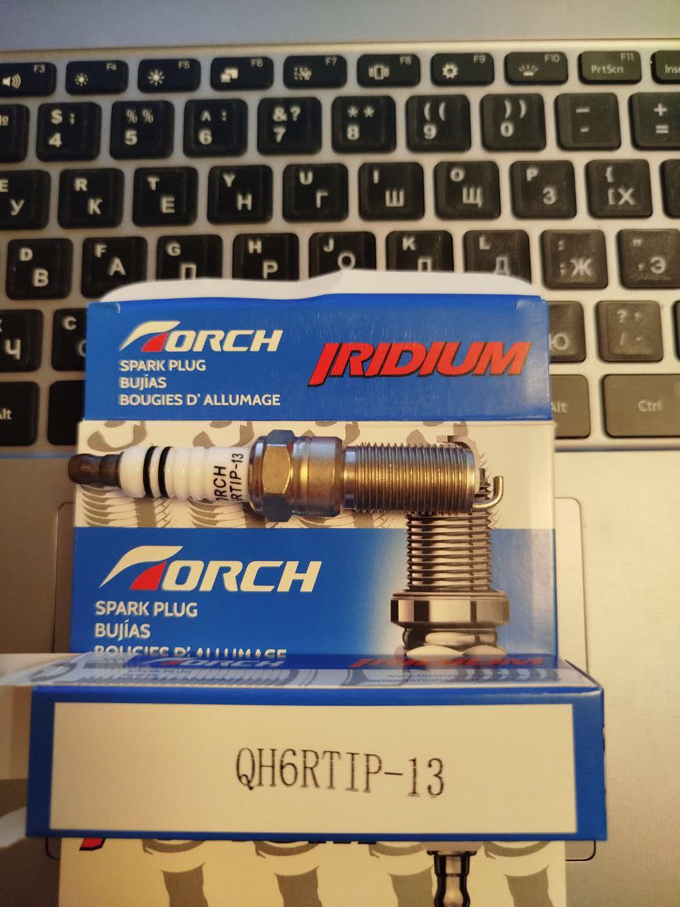 Photo of a spark plug ordered from AliExpress, referenced for comparison
