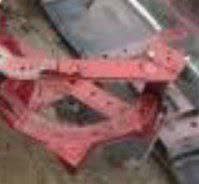 Accident damage photo showing the headlight mounting bracket area