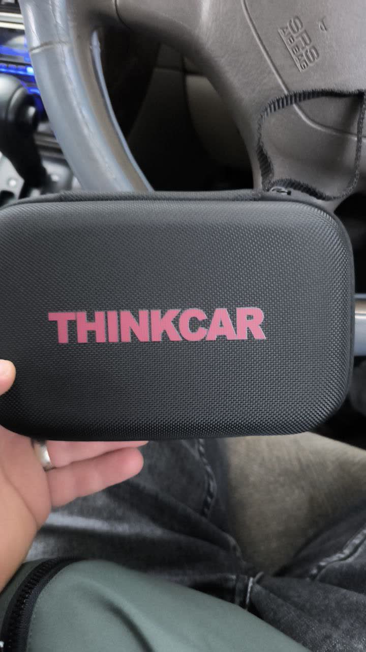 Photo of a rear caliper piston retraction tool (rotate-and-press type, similar to a "Launch"-branded tool) used during electronic-handbrake service-mode pad replacement