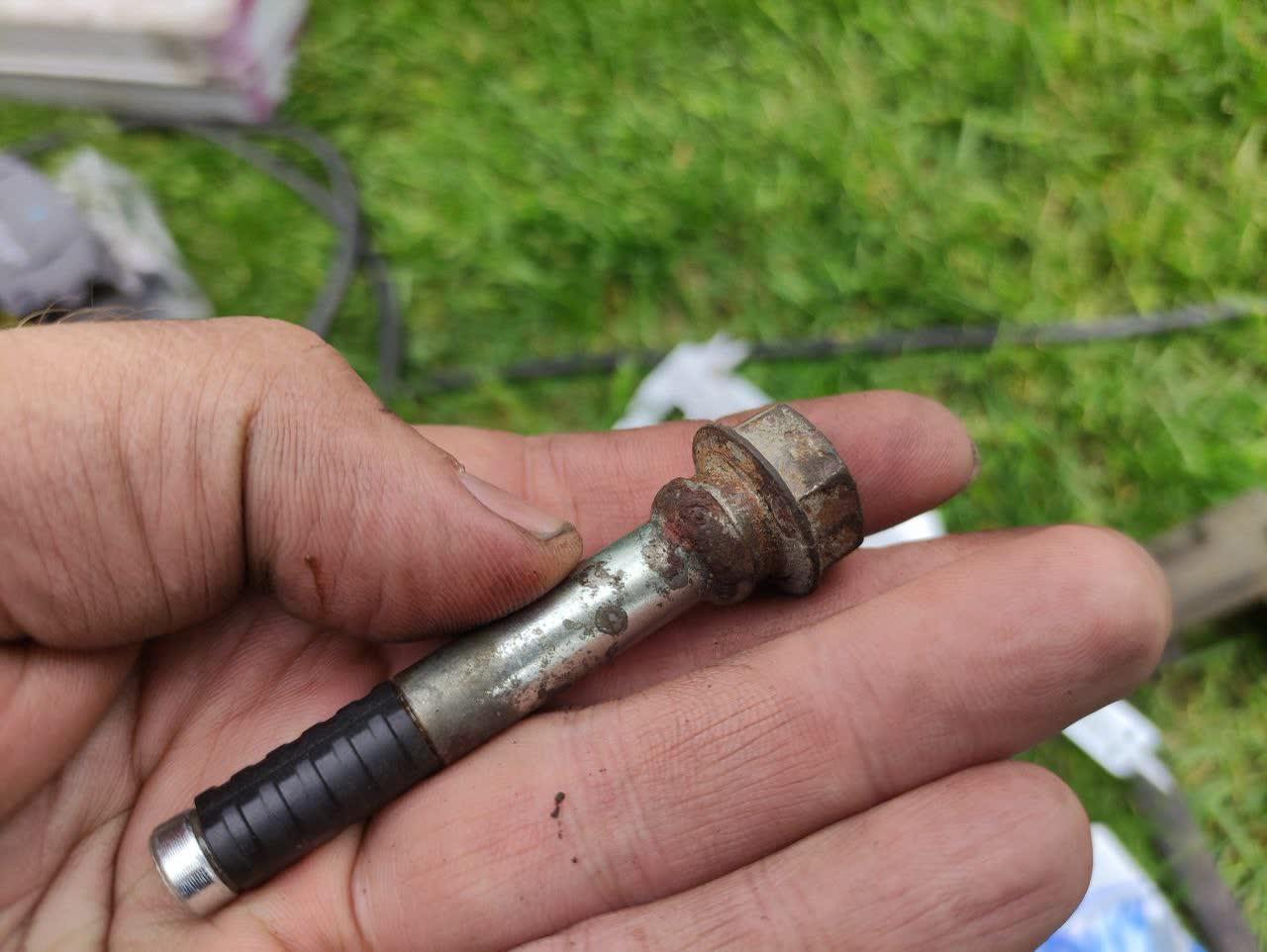 Photo of a corroded/rusted brake caliper guide pin removed for cleaning