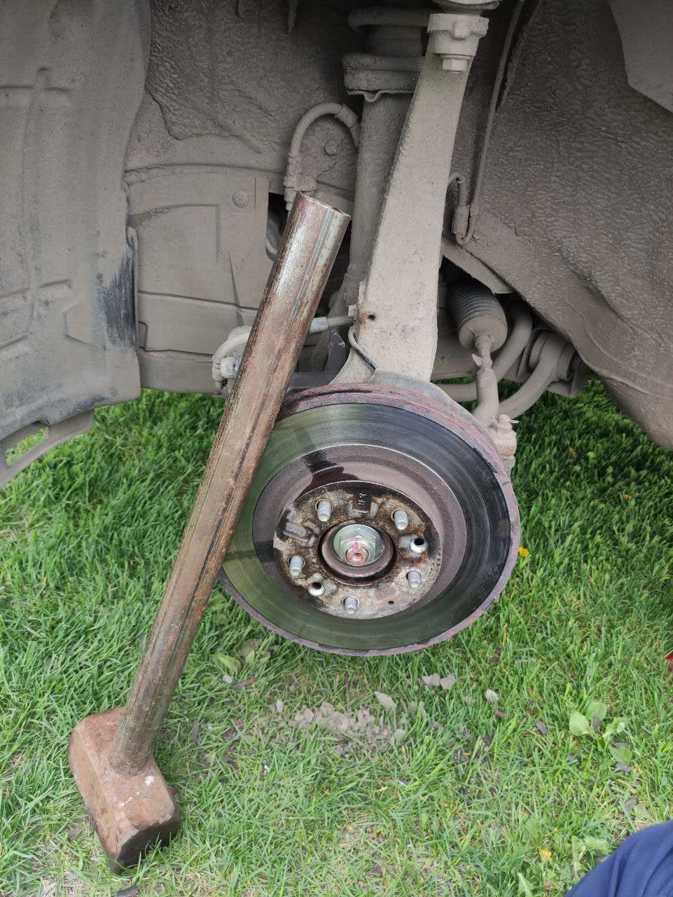 Photo of a mechanical brake disc puller tool used to remove a disc seized to the hub