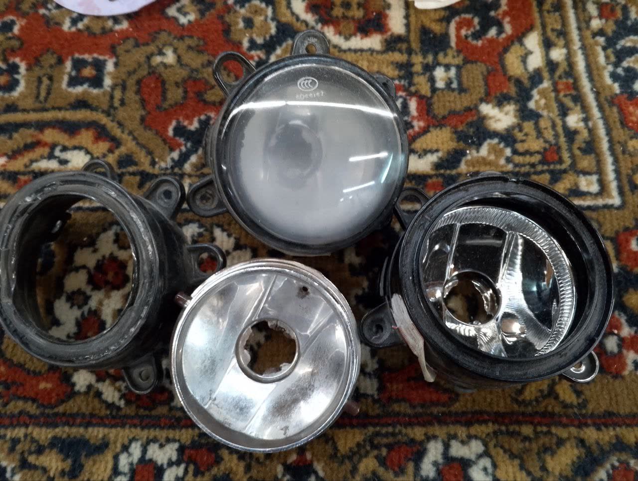 Collection of failed OEM rear fog lights showing typical deterioration pattern