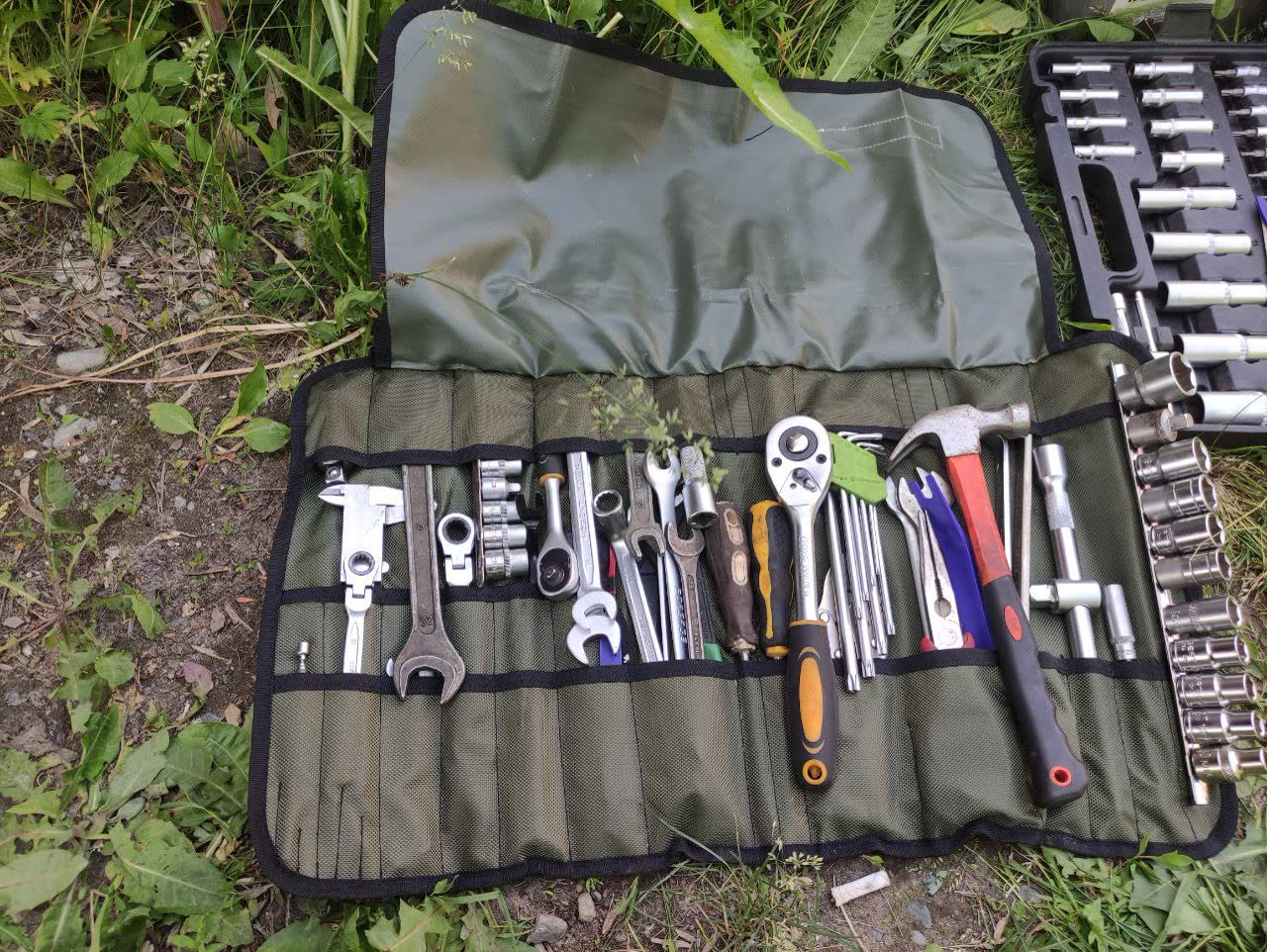 Spare wheel well used to store tools and emergency supplies in an organized bag