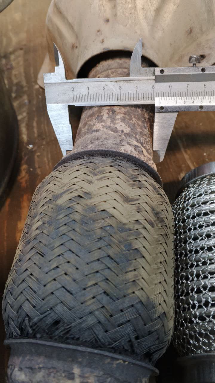 Intake manifold hose with diameter measurement (~55mm) using calipers