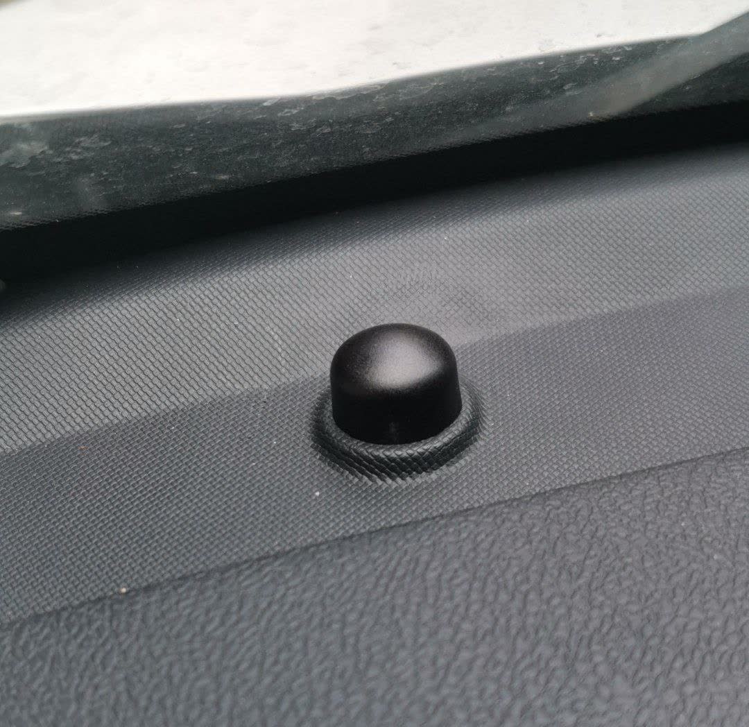 Close-up of the black spherical sensor mounted on the dashboard