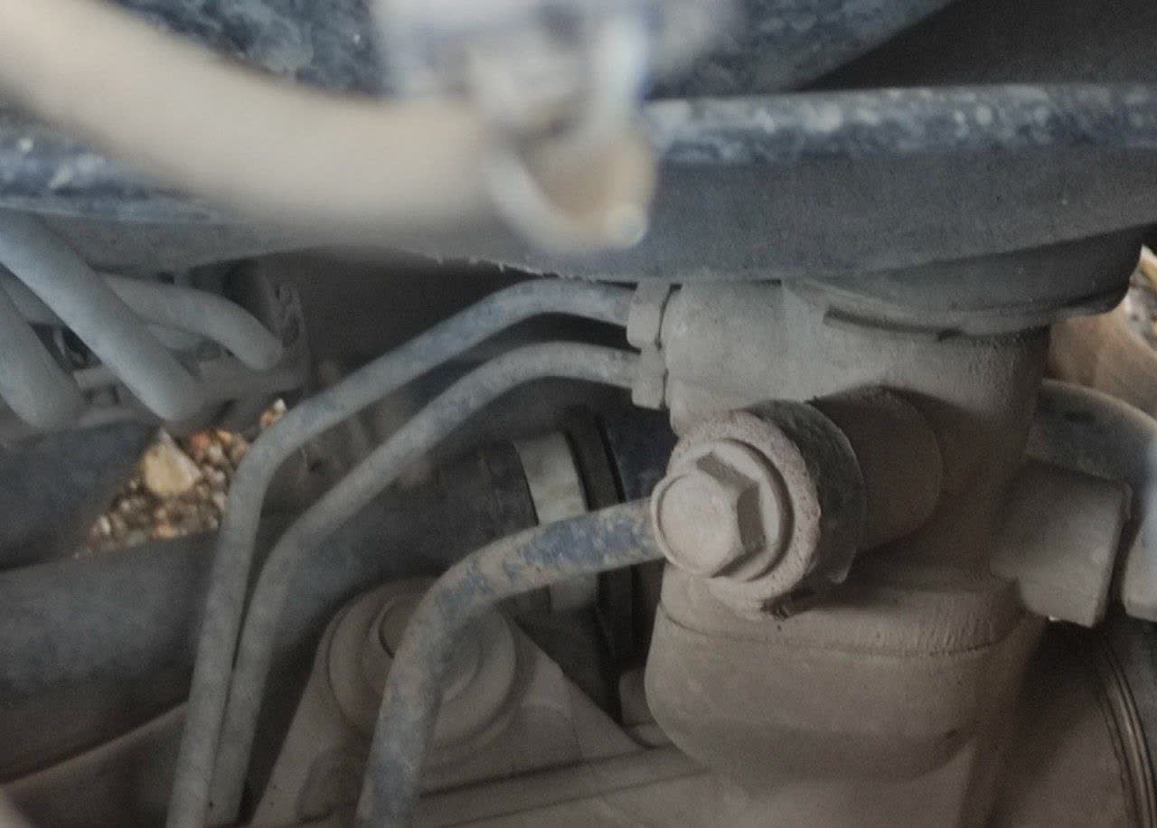 OEM polypropylene front stabilizer bushing after extended use, still intact with roughly 8mm of clearance visible