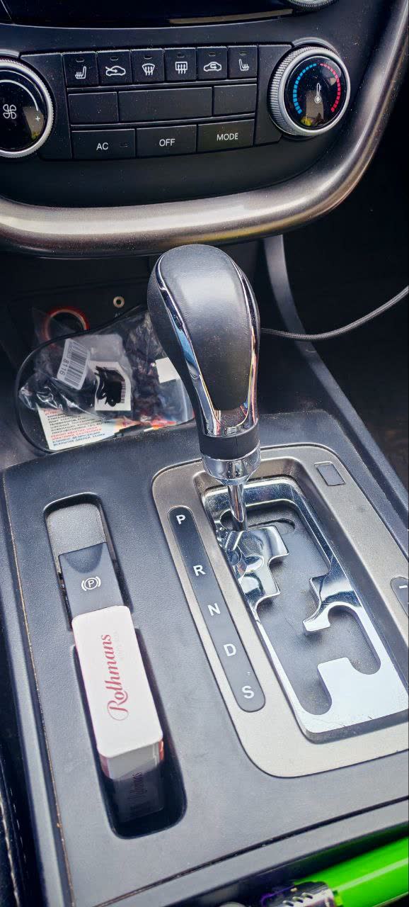 Worn shifter knob with peeling vinyl coating