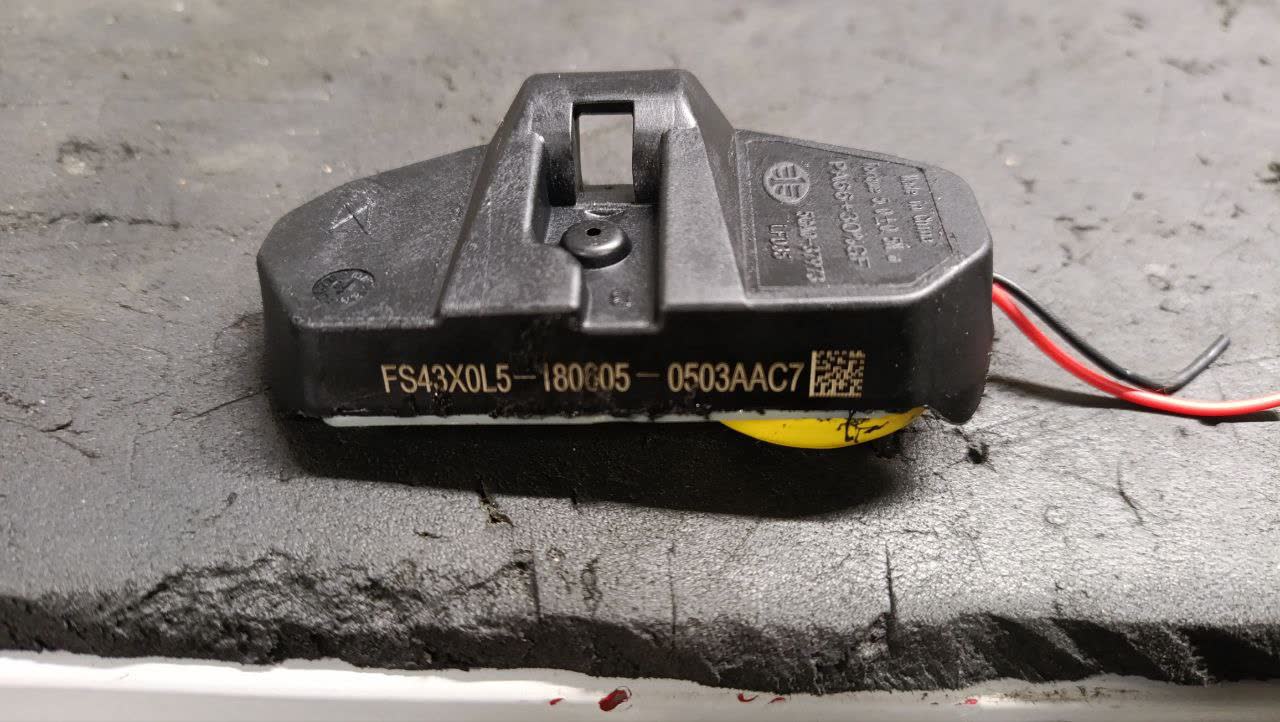 Black electronic component with part number FS43X0L5-180C05-0503AAC7 visible, with red/black wiring terminals