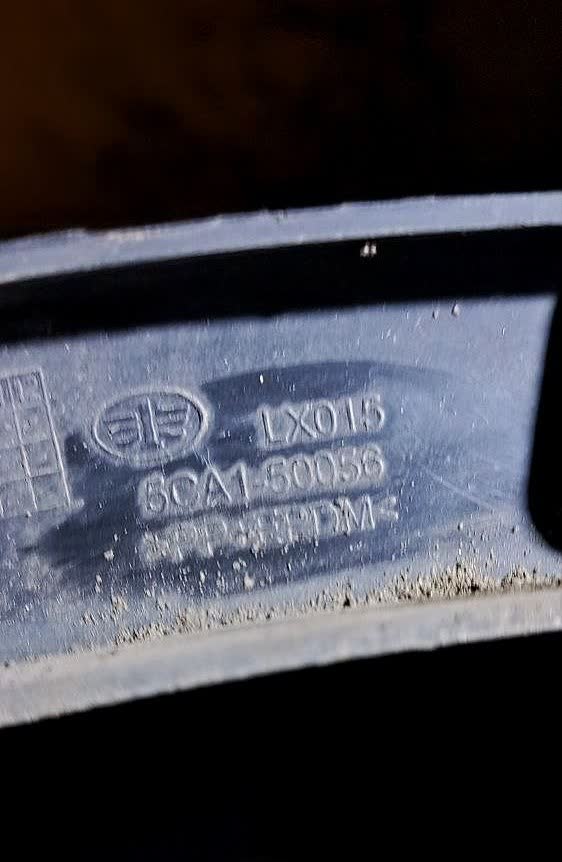 Right rear fender molding/trim piece showing part-number marking
