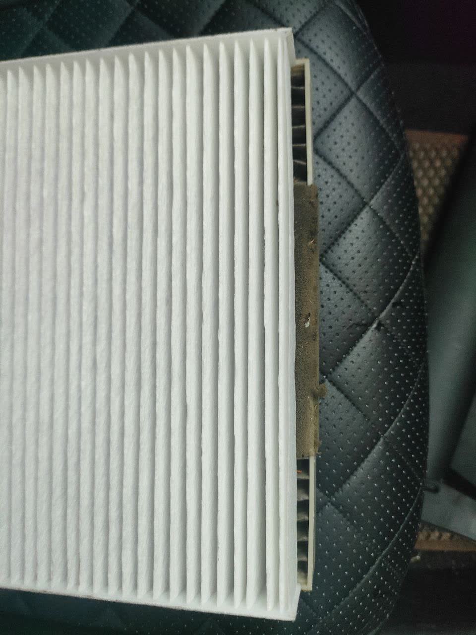 Photo comparing new (narrower) filter easily inserted next to old one