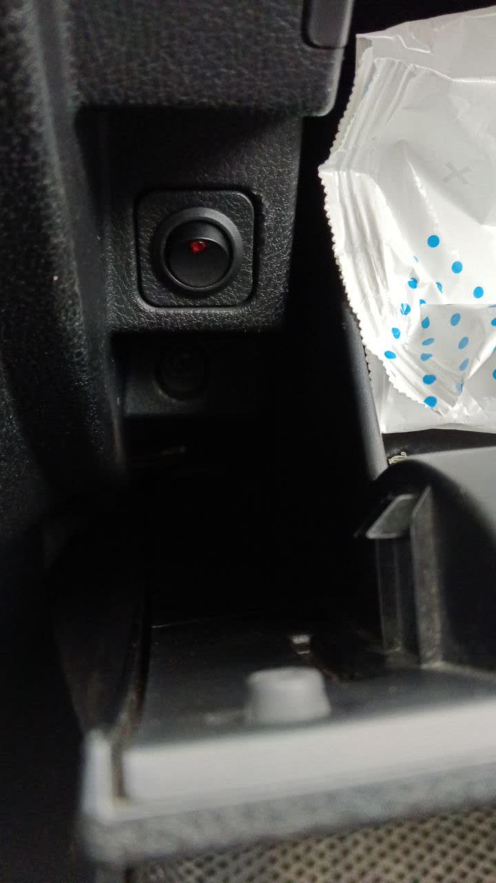 Photo showing the manual switch installed in the dash above the glove box, with the solenoid power wire cut and routed through it