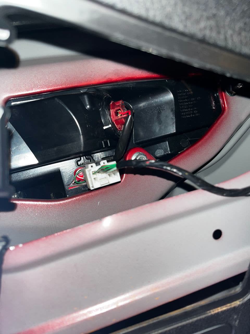 Rear light fixture with stuck bulb holder, red plastic socket visible