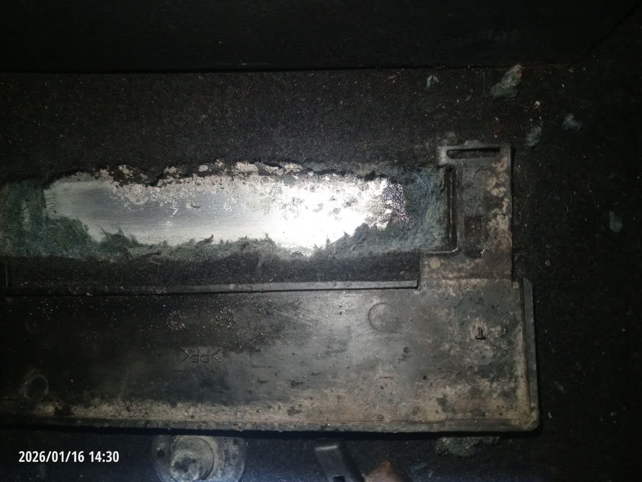 Flood-damaged vehicle interior showing water pooled in the front-passenger footwell area, cited as a pre-purchase inspection warning example