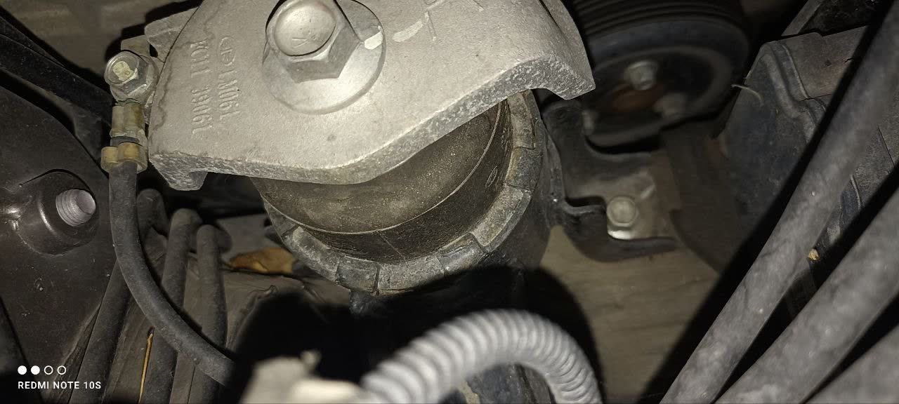 Worn engine mount showing compressed/sagged rubber and downward bracket movement