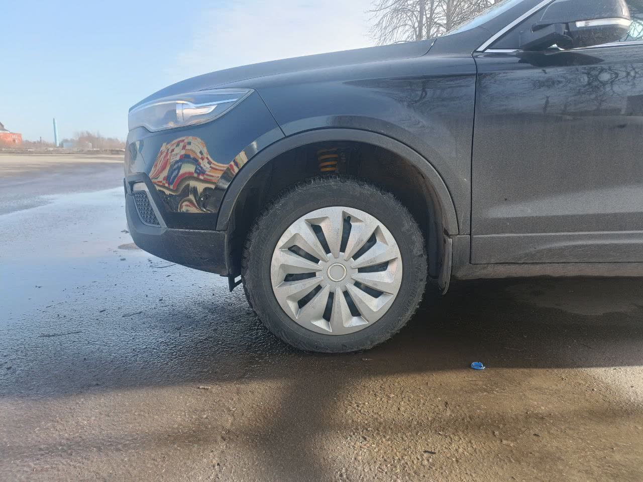Raised front end after new front spring installation, with measurement reference showing the height gain