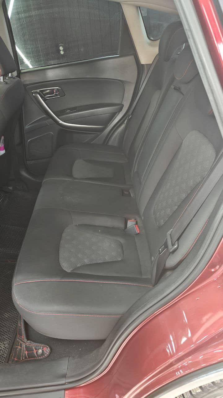 After photo: custom red leather seat covers with black trim on the driver seat