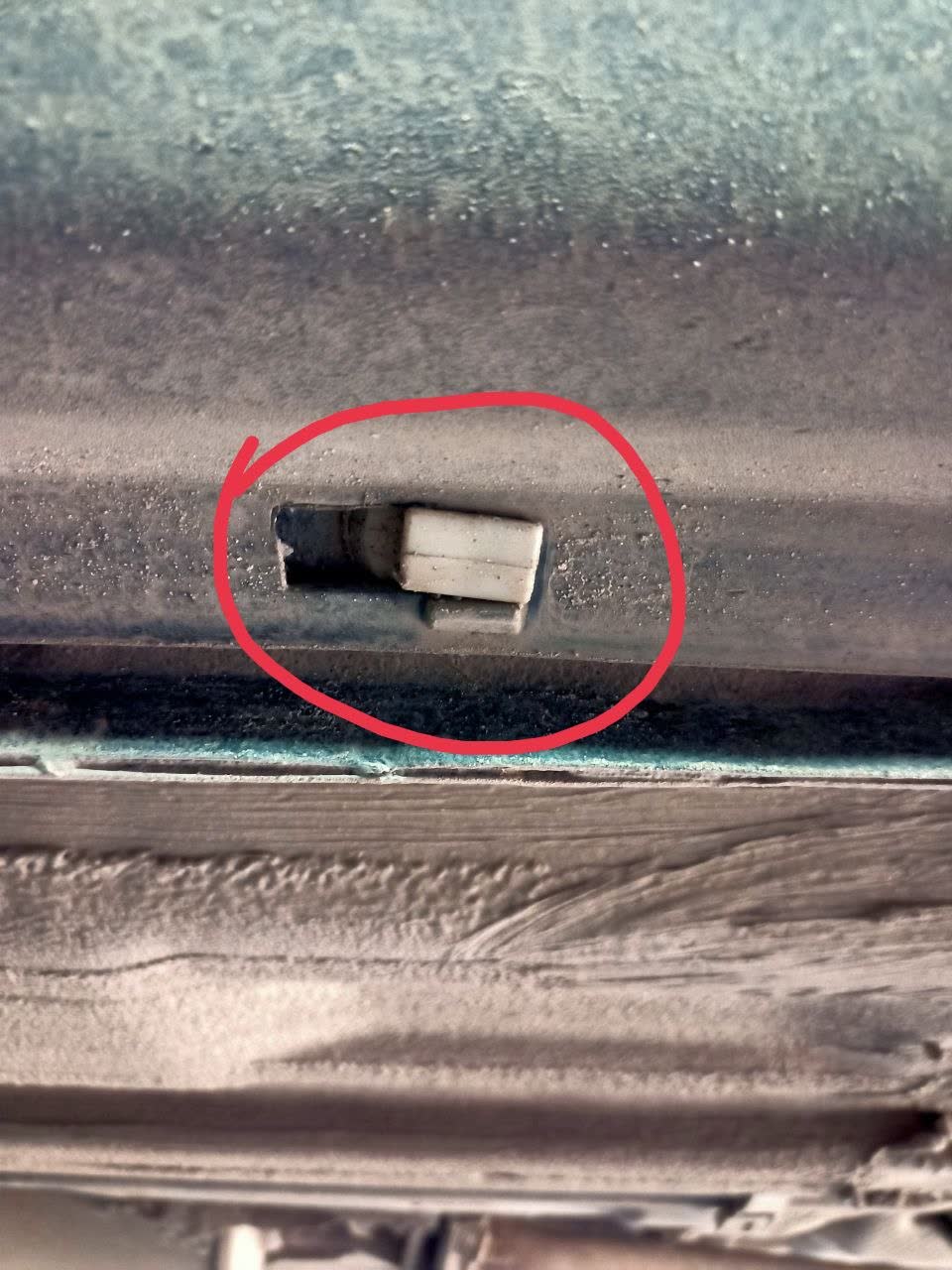 Close-up photo of the plastic clip fastener, showing its snap-fit design used to retain body/sill trim panels