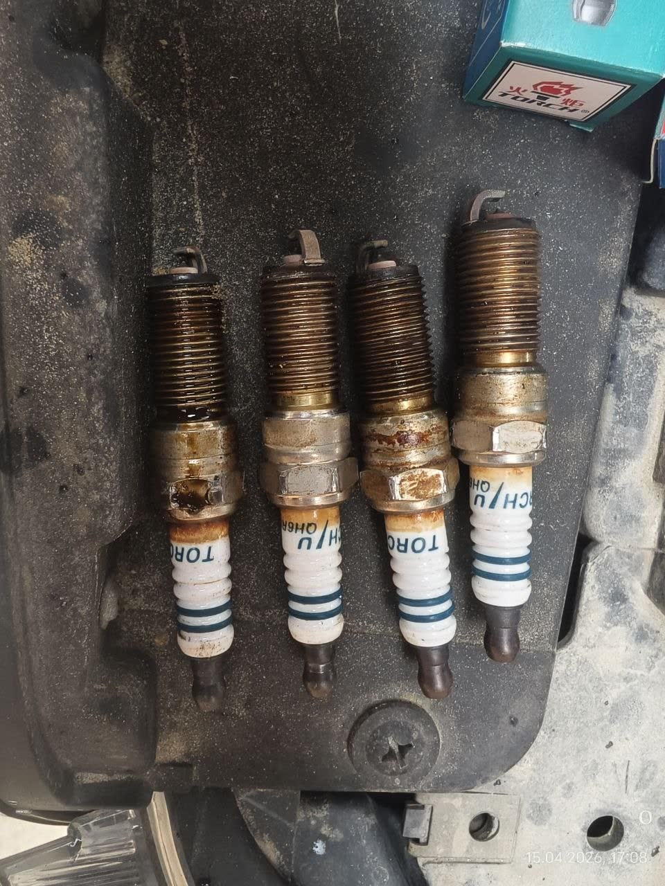 Photo of replaced spark plugs (TORCH QH5RIU-13) after installation