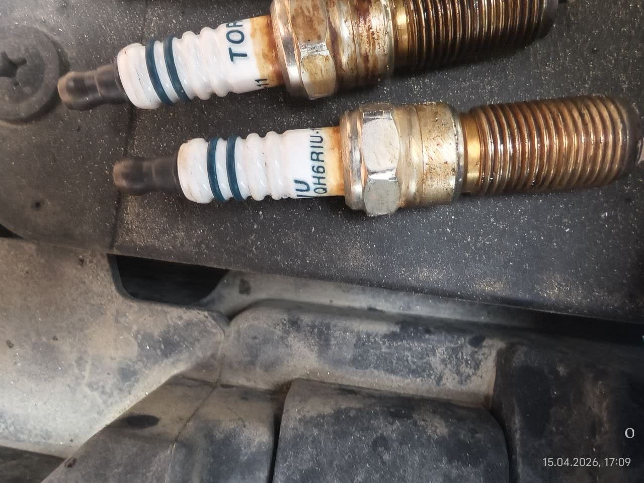 Photo of spark plug packaging showing old plug marking with "-11" suffix code
