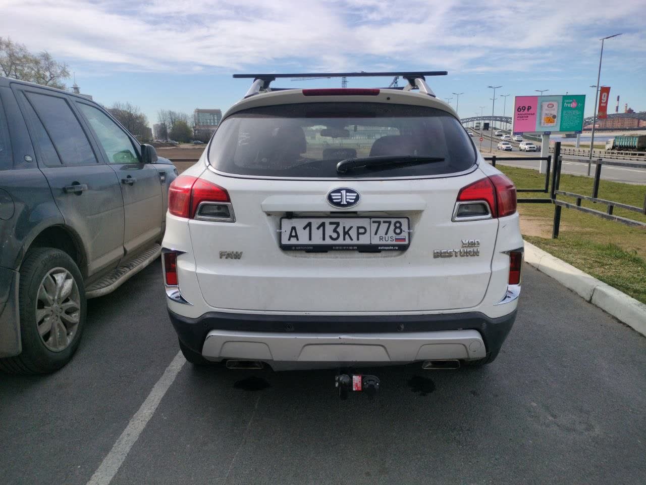 Black plastic fender lip guard installed on a white X80