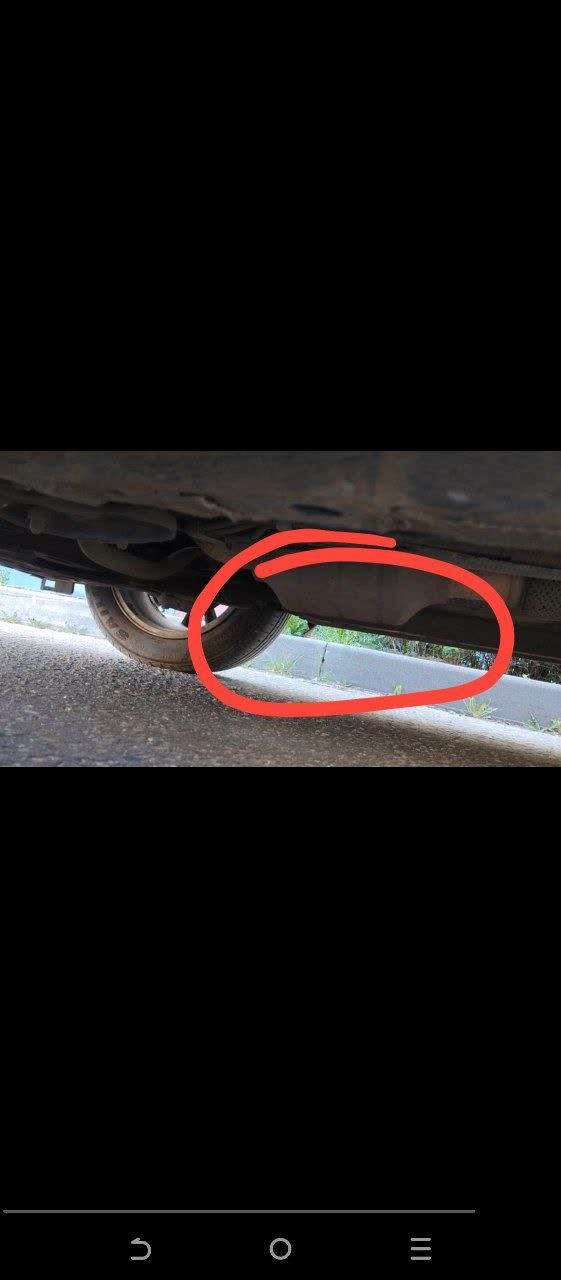 Photo of the exhaust heat shield showing damage/separation from its mounting points
