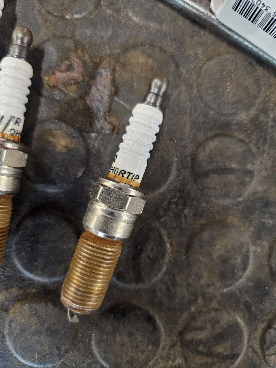 Second spark plug from the same 30,000 km inspection, showing similar wear