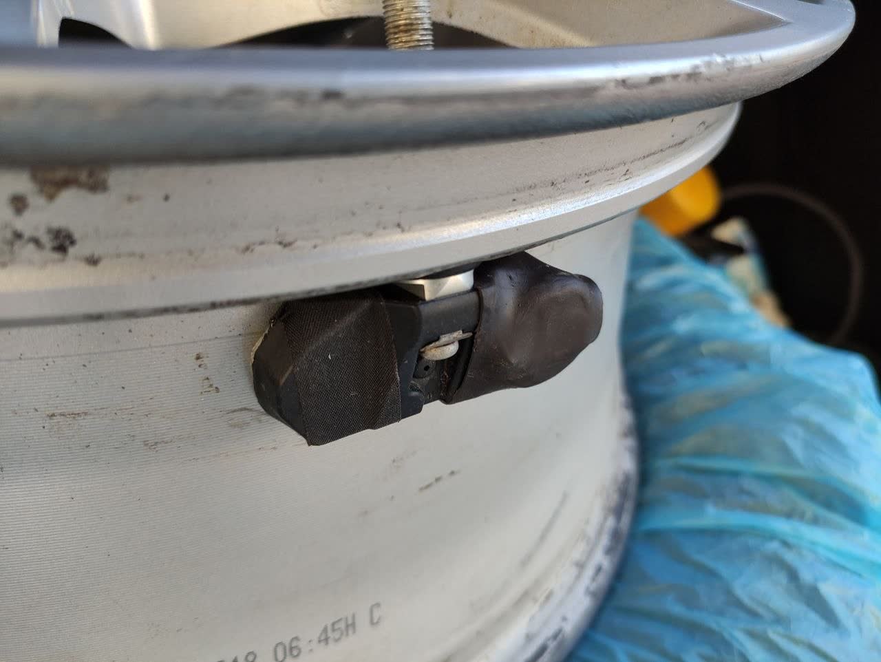 Photo illustrating the difficulty of extracting a glued-in original sensor battery, supporting the "external battery, not recommended" DIY warning