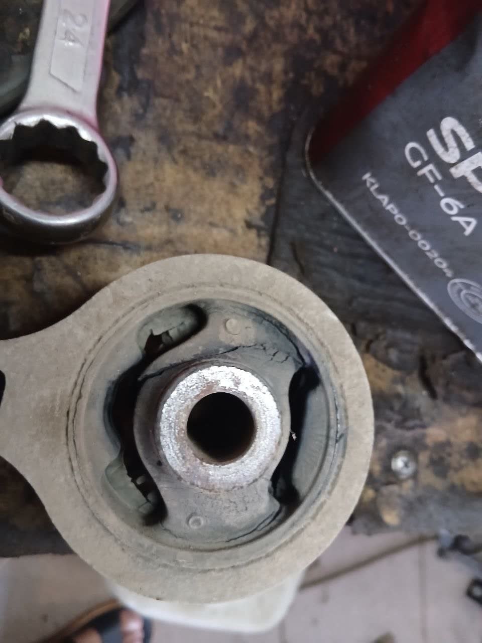 Comparison photo: Mazda6-reference rear mount (cleaner finish, marked 1200 RUB) vs. analog mount (marked 2500 RUB), showing visual quality variance despite both fitting correctly