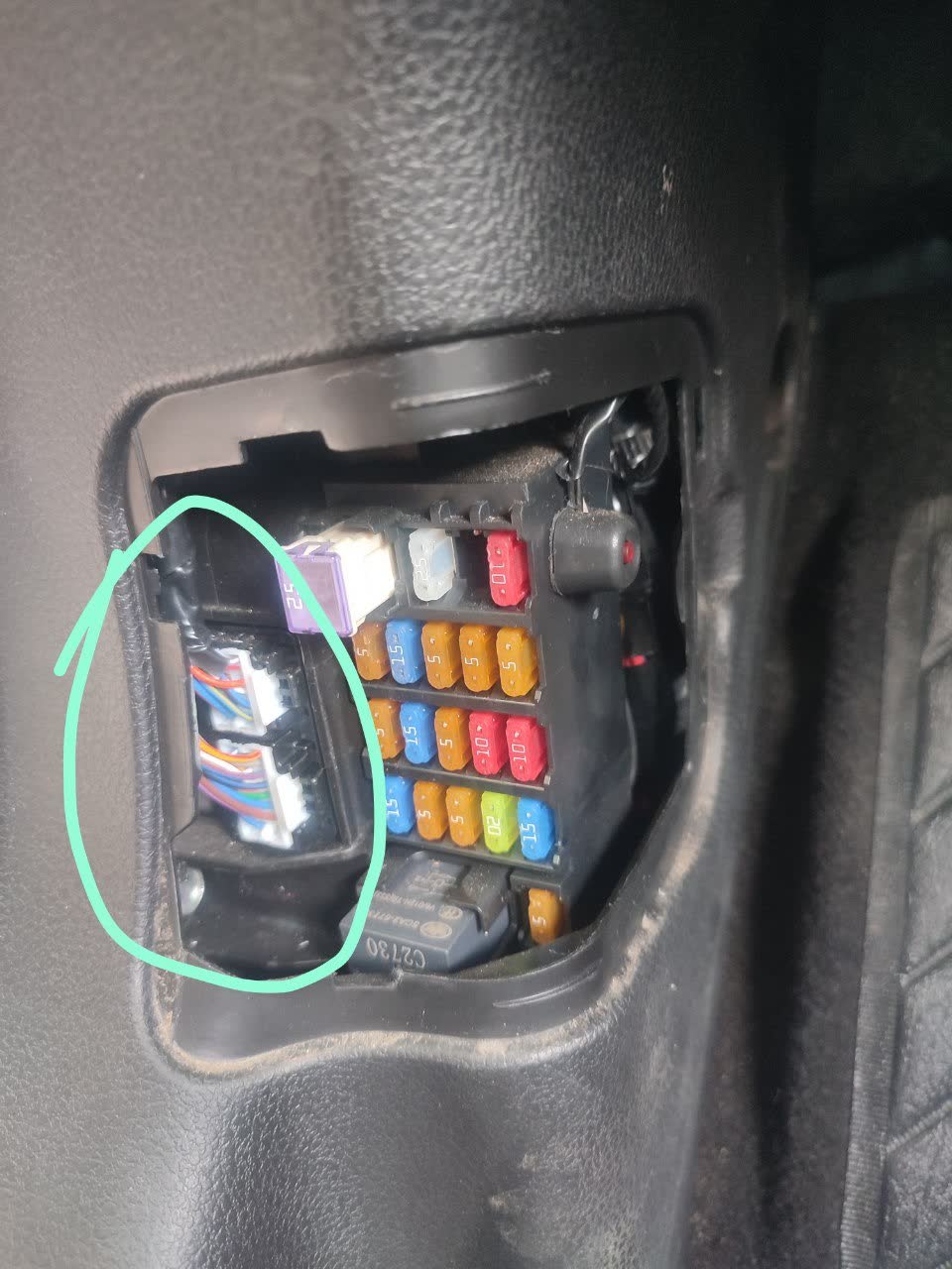 Photo of the BSM block/connector area inspected for green corrosion after a water leak under the driver's mat on a restyled X80
