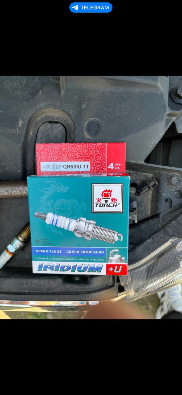 Photo shows TORCH brand iridium spark plugs, model QH6RIU-11, in packaging, a 4-piece set; brand appears Chinese (torch symbol in Chinese characters); "Iridium +U" designation